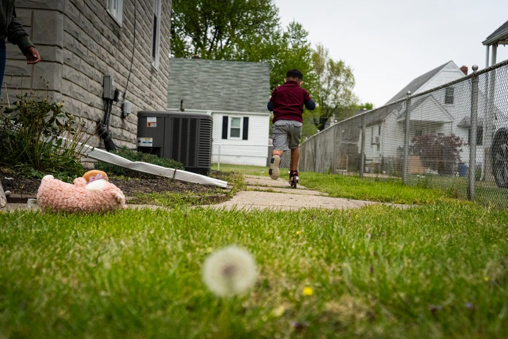 Frank, 7, plays outside of his home in Baltimore.